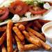 A pita sandwich filled with spinach, arugula, rosemary chicken, goat cheese, and vegetables with a side of sweet potato fries and chipotle ranch on Tuesday. Daniel Brenner I AnnArbor.com